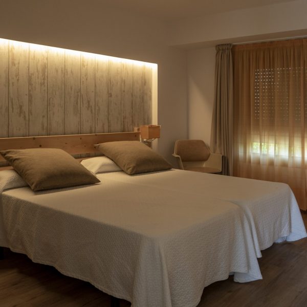 An interior of a bedroom in white and creamy tones