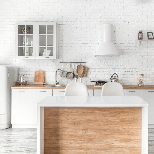 Modern stylish Scandinavian kitchen interior with kitchen accessories. Bright white kitchen with household items .